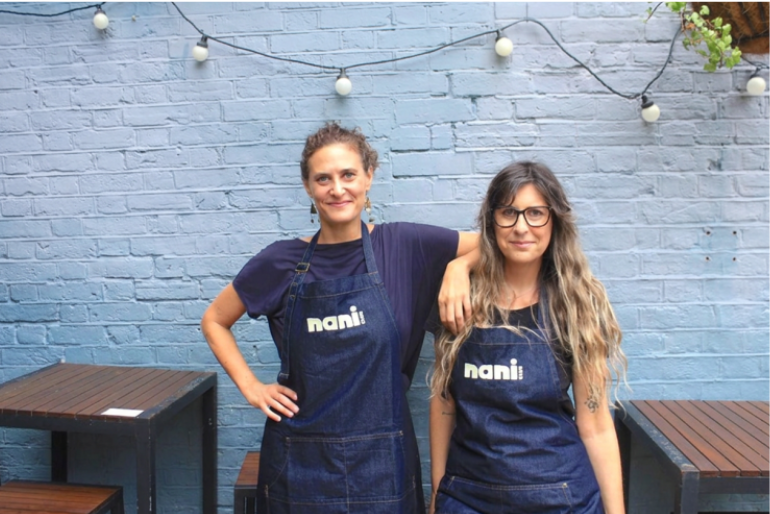 Nani Club founders Ilana and Karina Rehavia wearing Nani Club aprons
